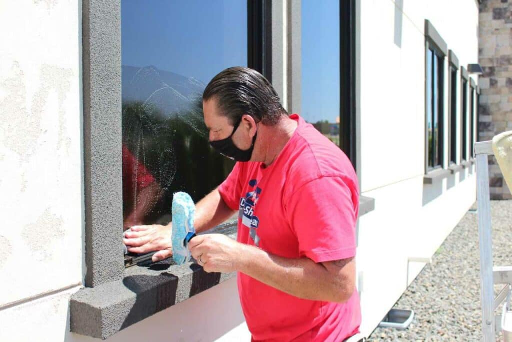 professional cleaner cleaning the window exterior Dura-Shine Clean