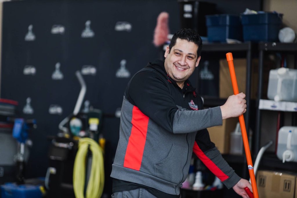 Dura-Shine Clean staff holding a cleaning equipment